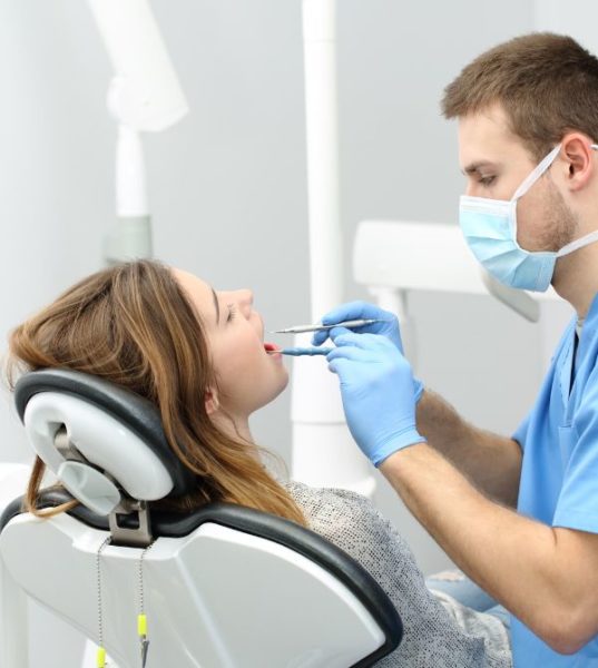 Dentist performing dental procedure on patient